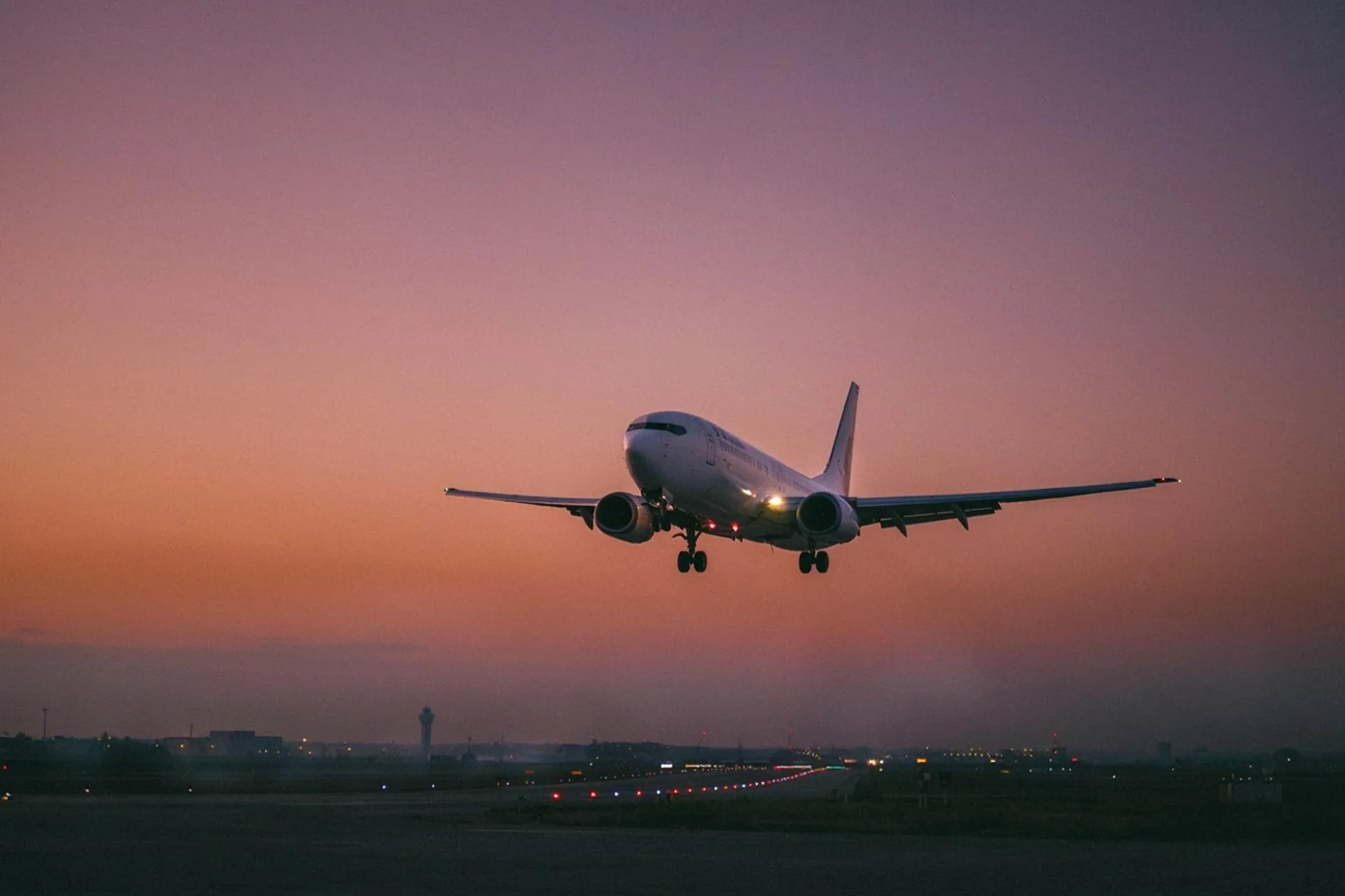 Boeing 737 on final approach at dusk